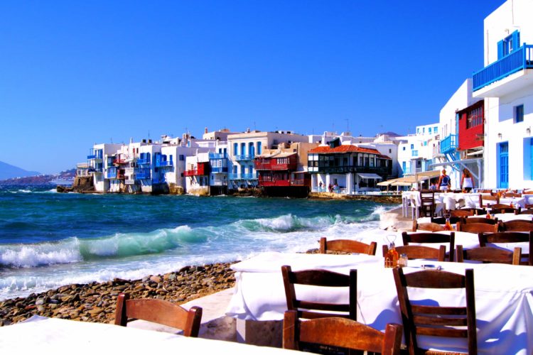 table and chairs on beach in Greece