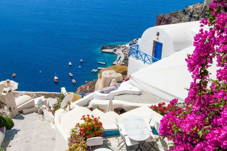 Aerial shot of Santorini white buildings and blue sea