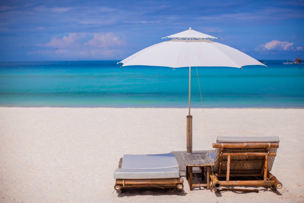 Beach wooden chairs for vacations on tropical beach