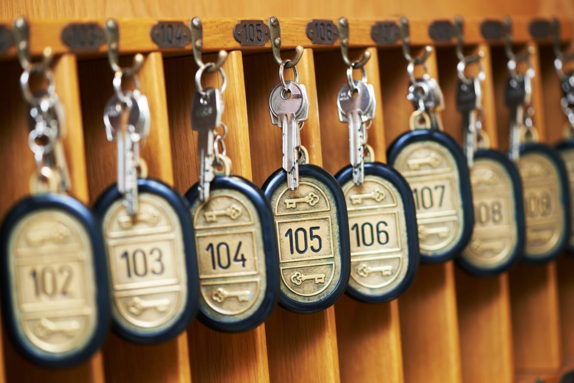 high-end hotel room keys hang on rack