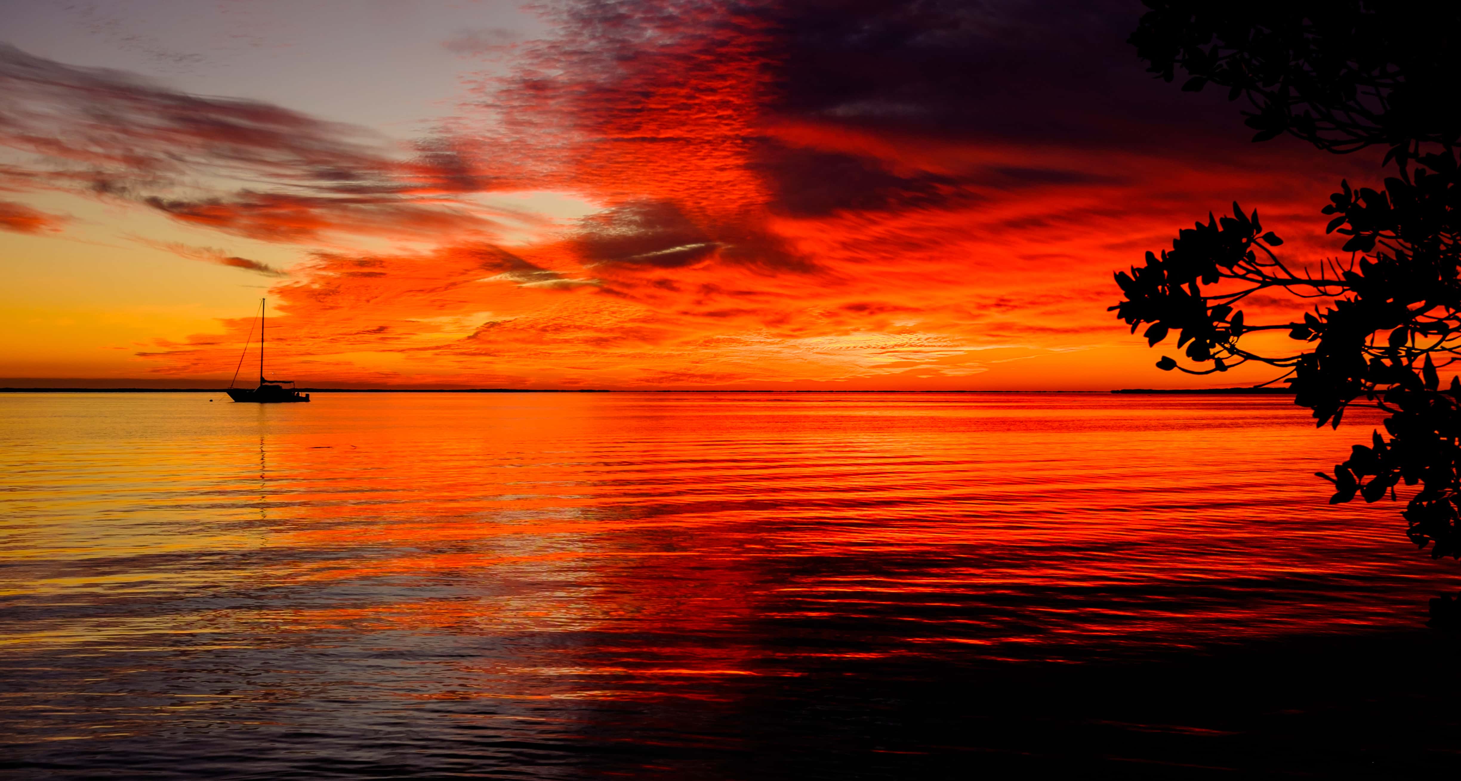 sunset in the Florida Keys with sailboat in distance