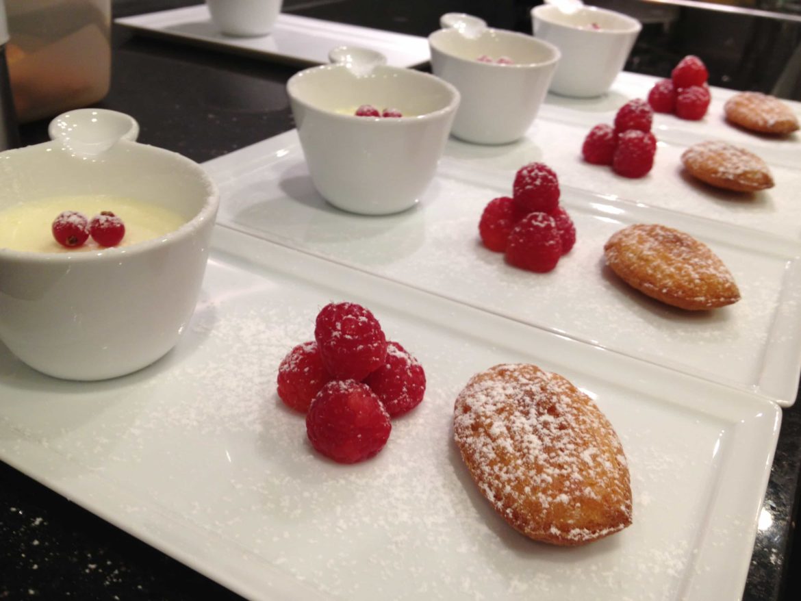 Lemon posset served with Madeleines and raspberries