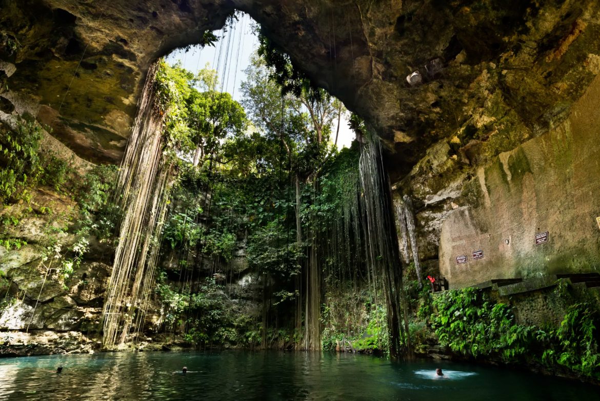 Ik Kill Cenote, a rainforest cave pool that drips with jungle vines.