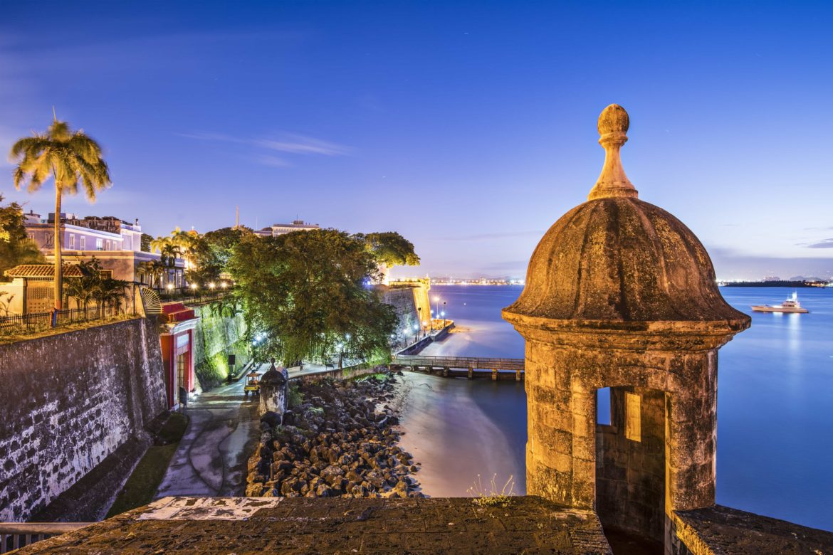 San Juan, Puerto Rico at dusk with a yacht in the harbor