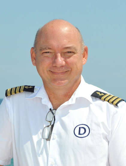 yacht captain smiling in uniform