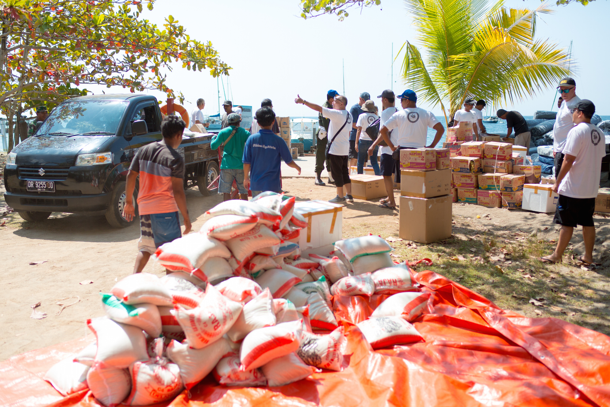 people on beach organizing donations for earthquake relief