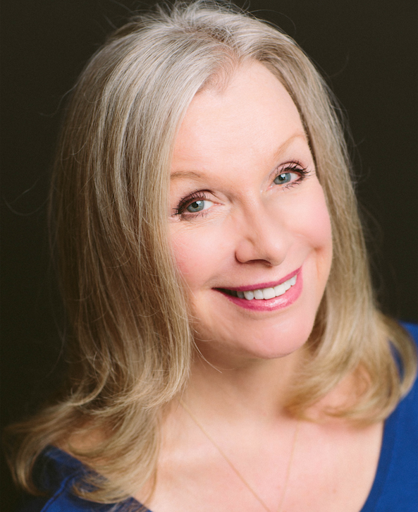 woman smiling against black wall