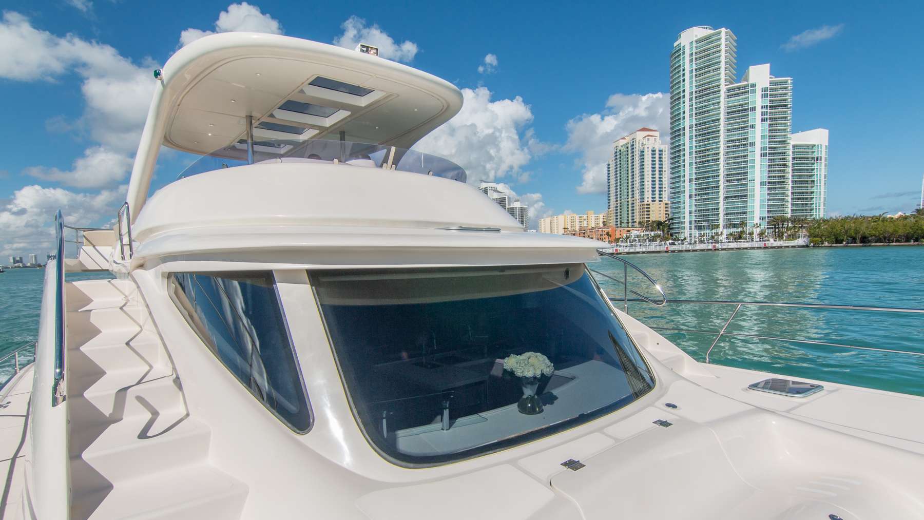 man underwater snorkelling with yacht above the water in the distance