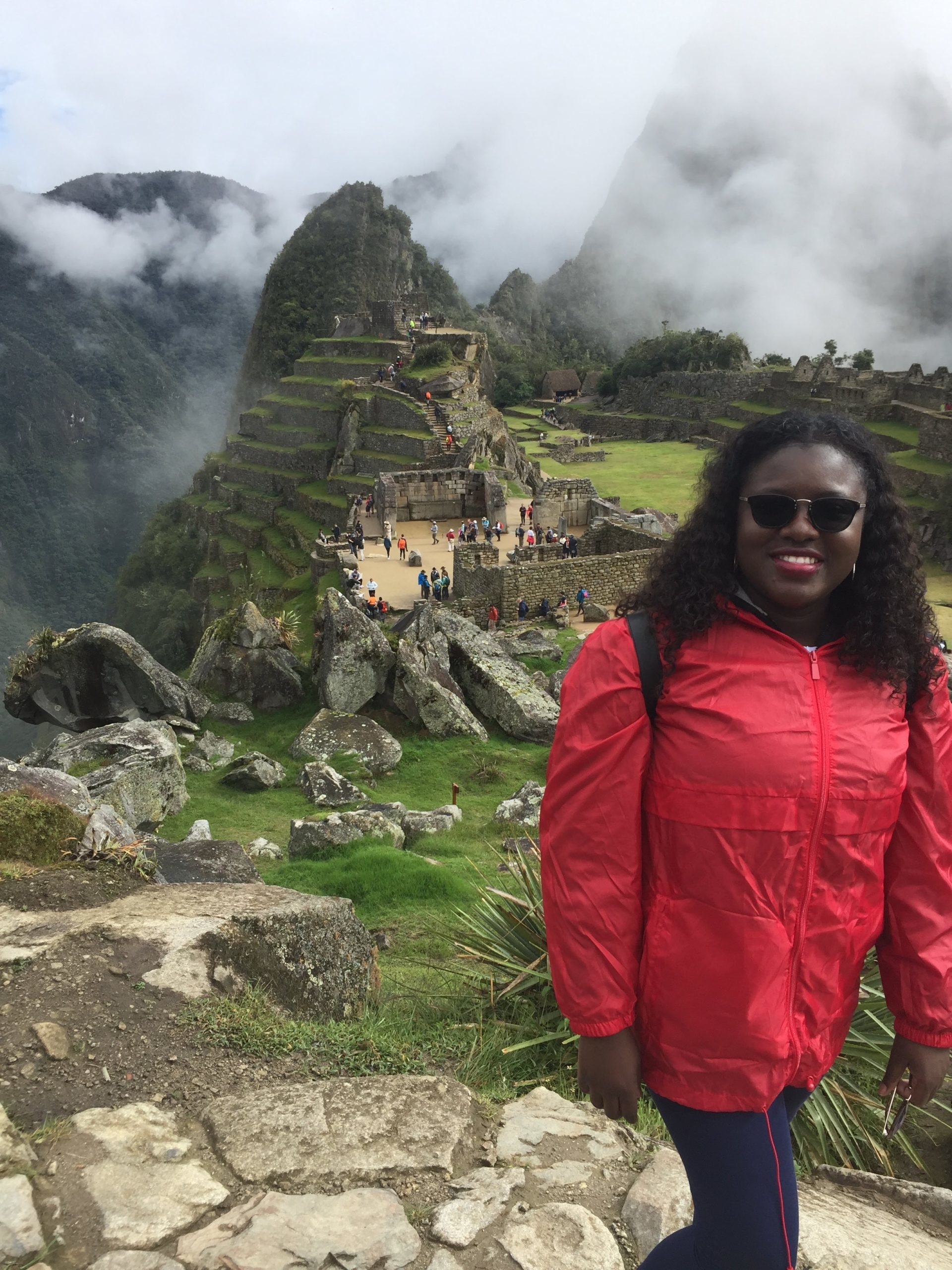 Black woman standing in front of Machu Picchu