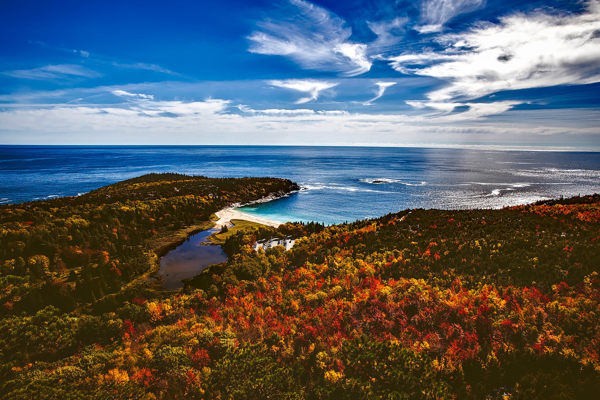 aerial shot of the coastline of Maine with coloured leaves in the fall