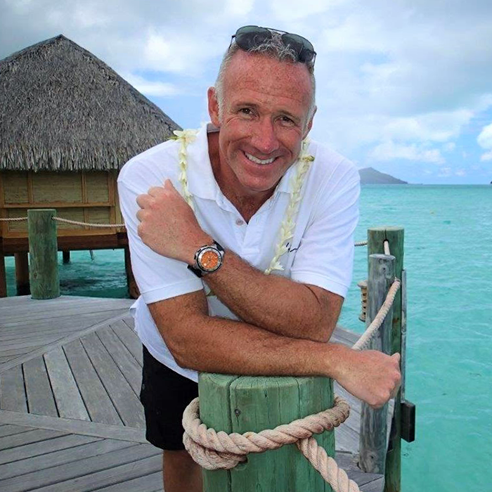 Tahiti travel expert Carl Henderson in front of over water bungalow in Tahiti