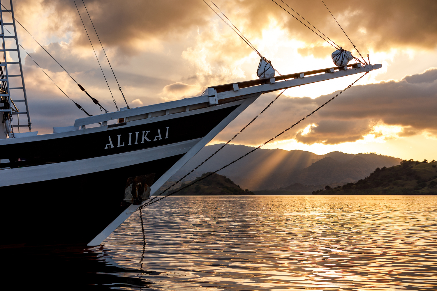 bow of Aliikai yacht with sunset in the background