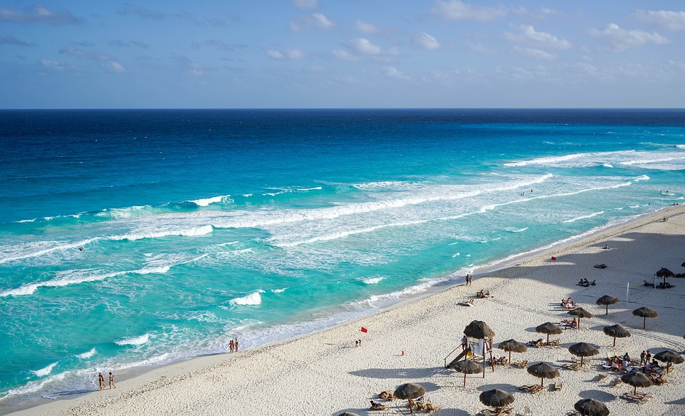 white sand beach in Mexico with blue surf