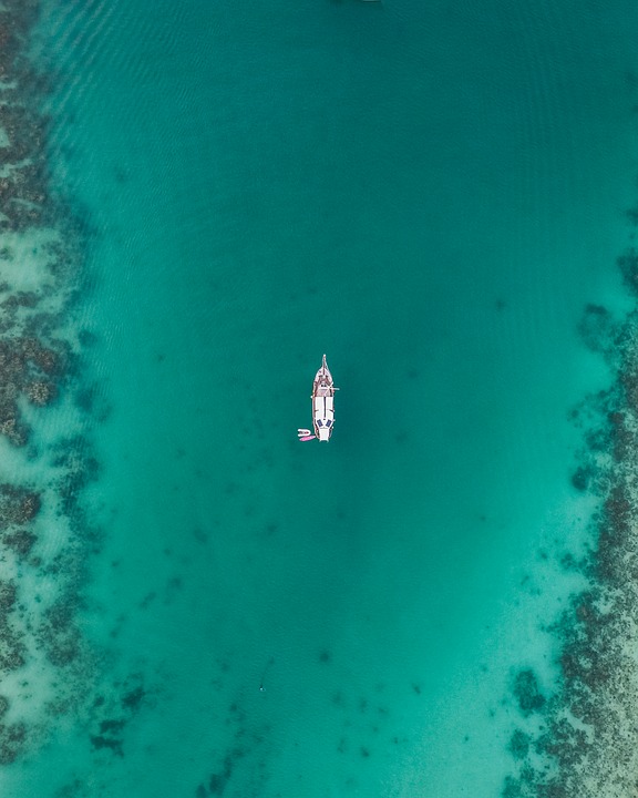 aerial of superyacht in blue lagoon