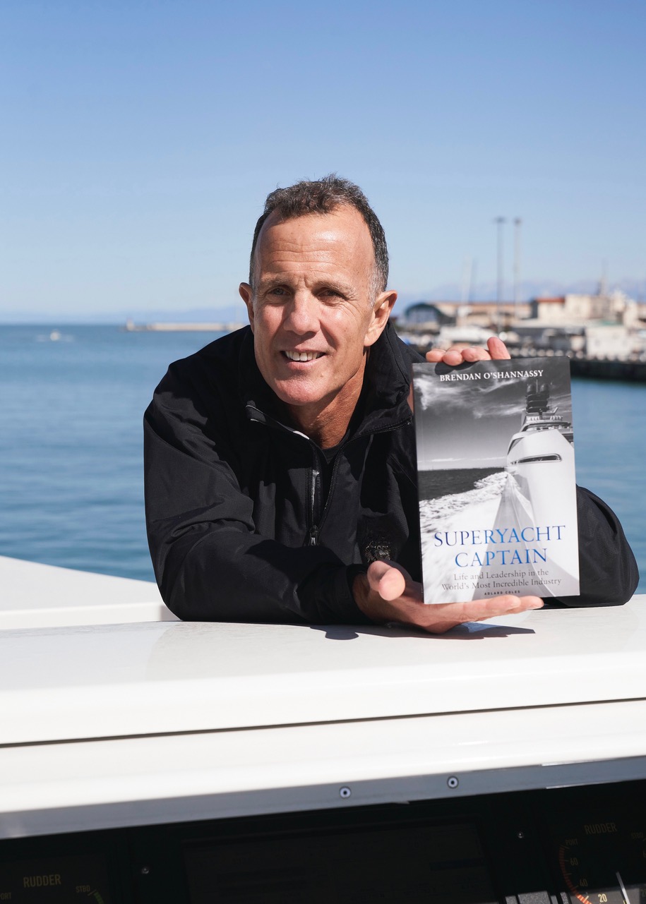 Captain Brendan O'Shannassy holds his newly published book