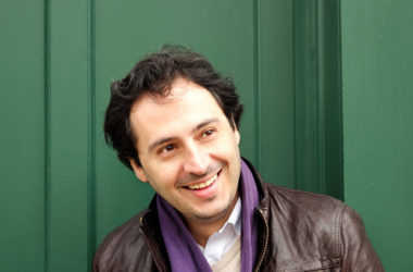 ricardo araujo smiling in front of green door