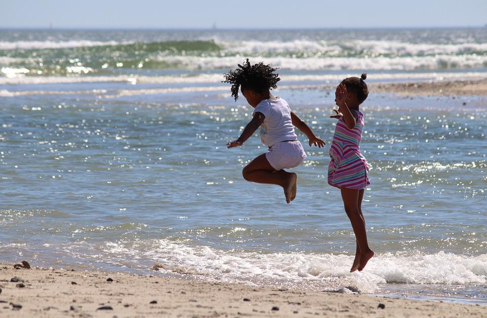 african children jumping on the beach