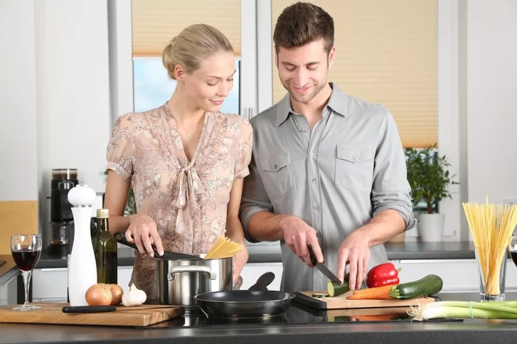white couple cooking in the kitchen